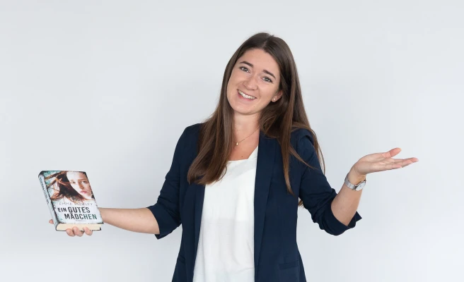 Employee Carina Mayr with a book