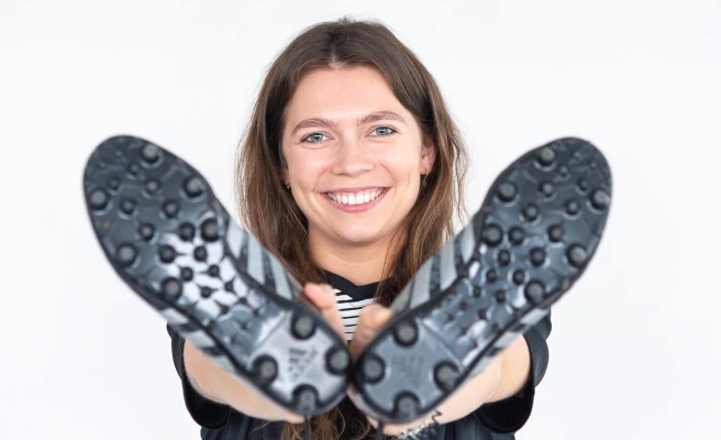 Employee Christine Becker with soccer shoes