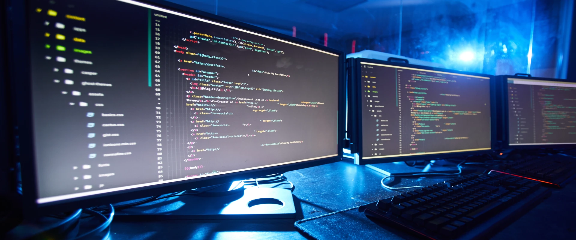 Several computer screens next to each other showing lines of code.