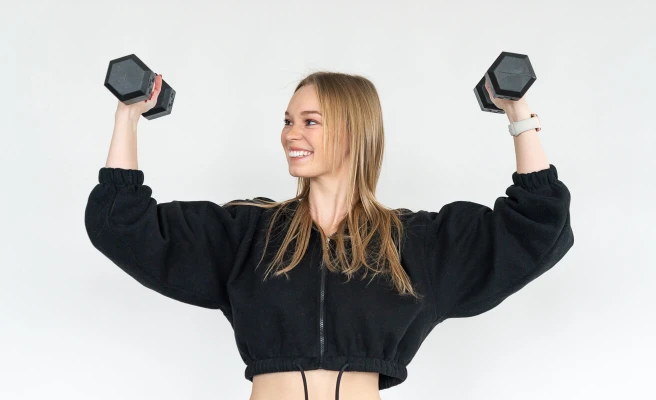 Employee Ines Wiedermann lifts two weights