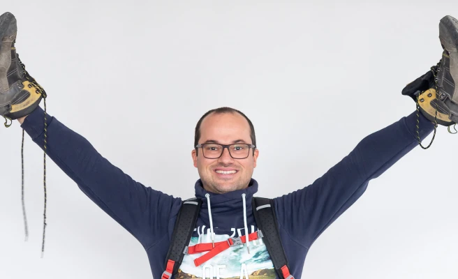 Employee Michael Brückler holds up his hiking boots.