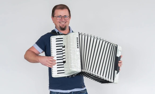 Employee Walter Stech plays the accordion.