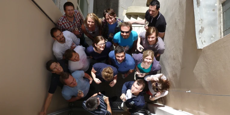 Employees stand on the balcony during a visit to the Vienna office.